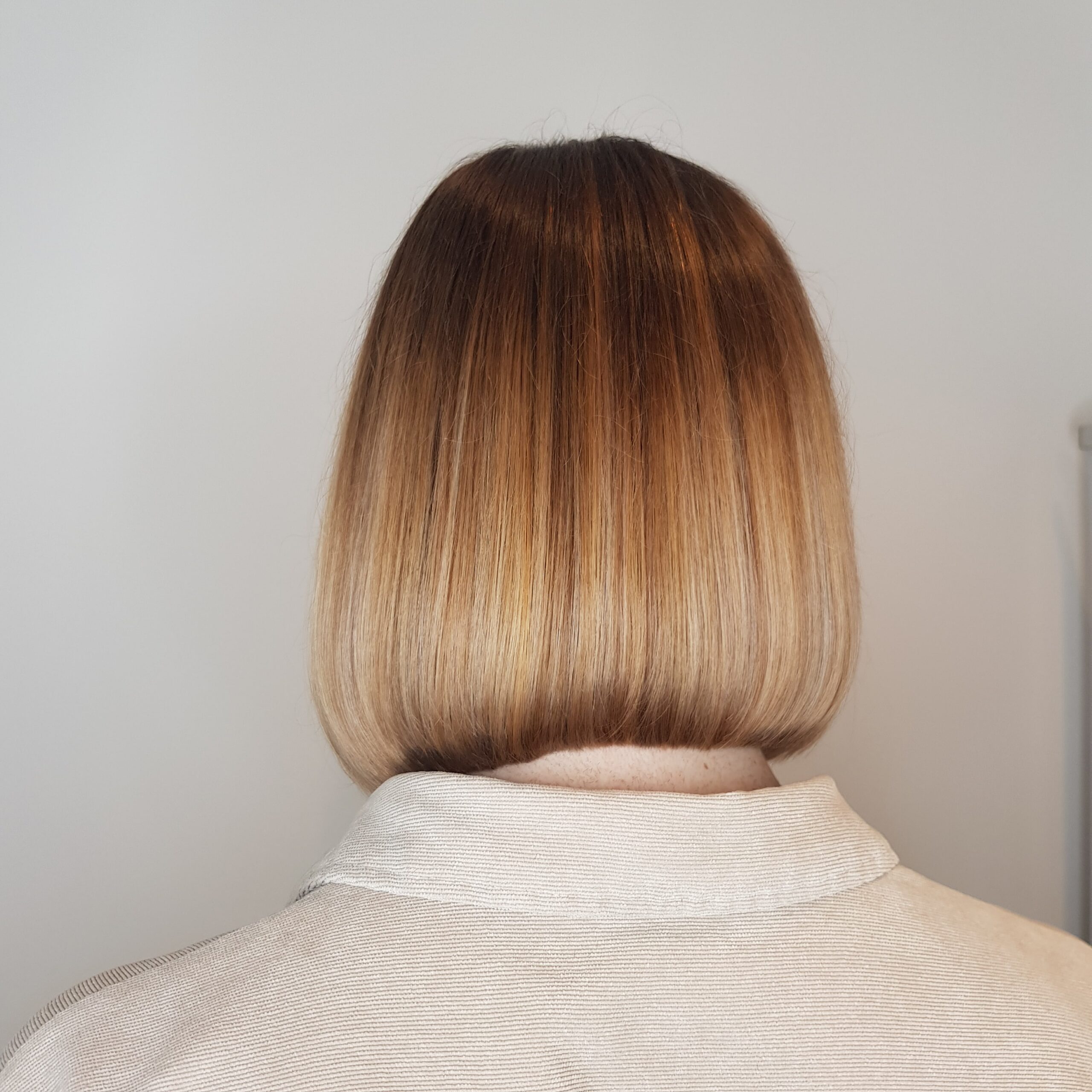 a bob haircut with half head balayage colour