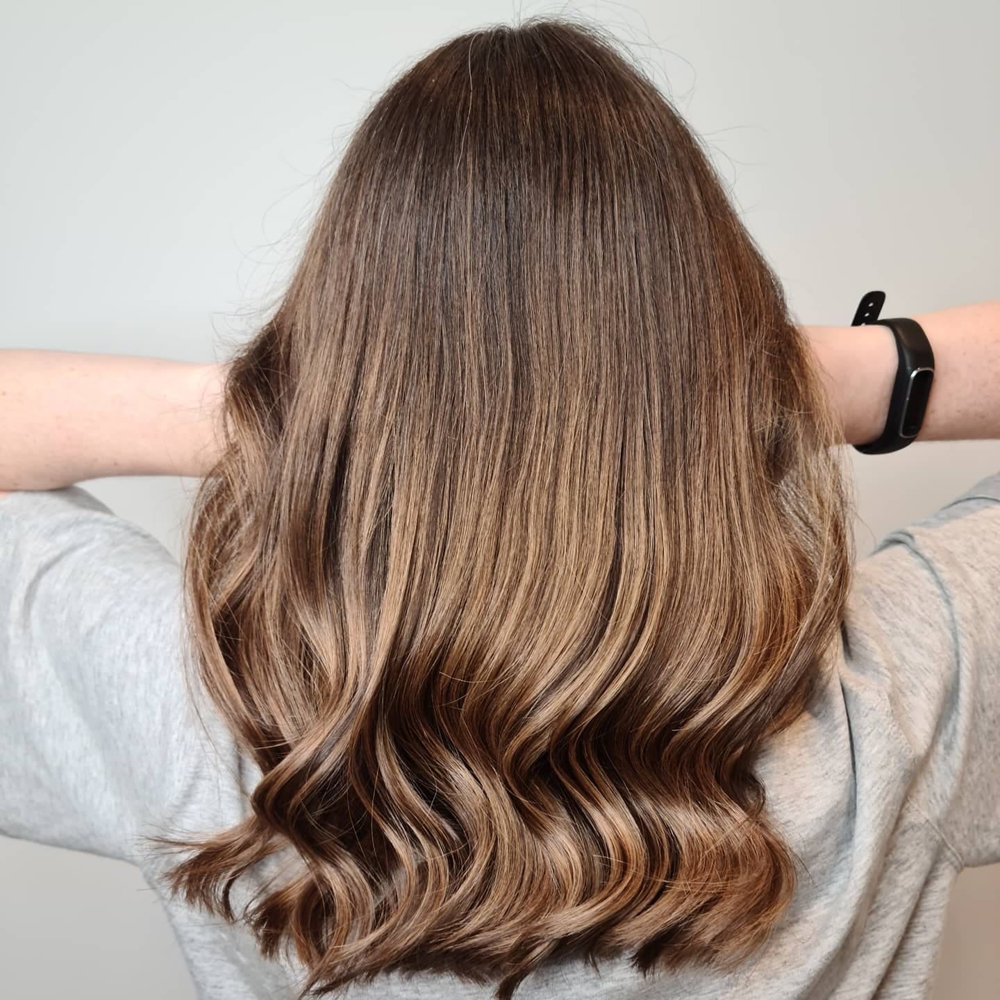 the back of a woman's head showing off her balayage hair colour done on long, mid-back length hair