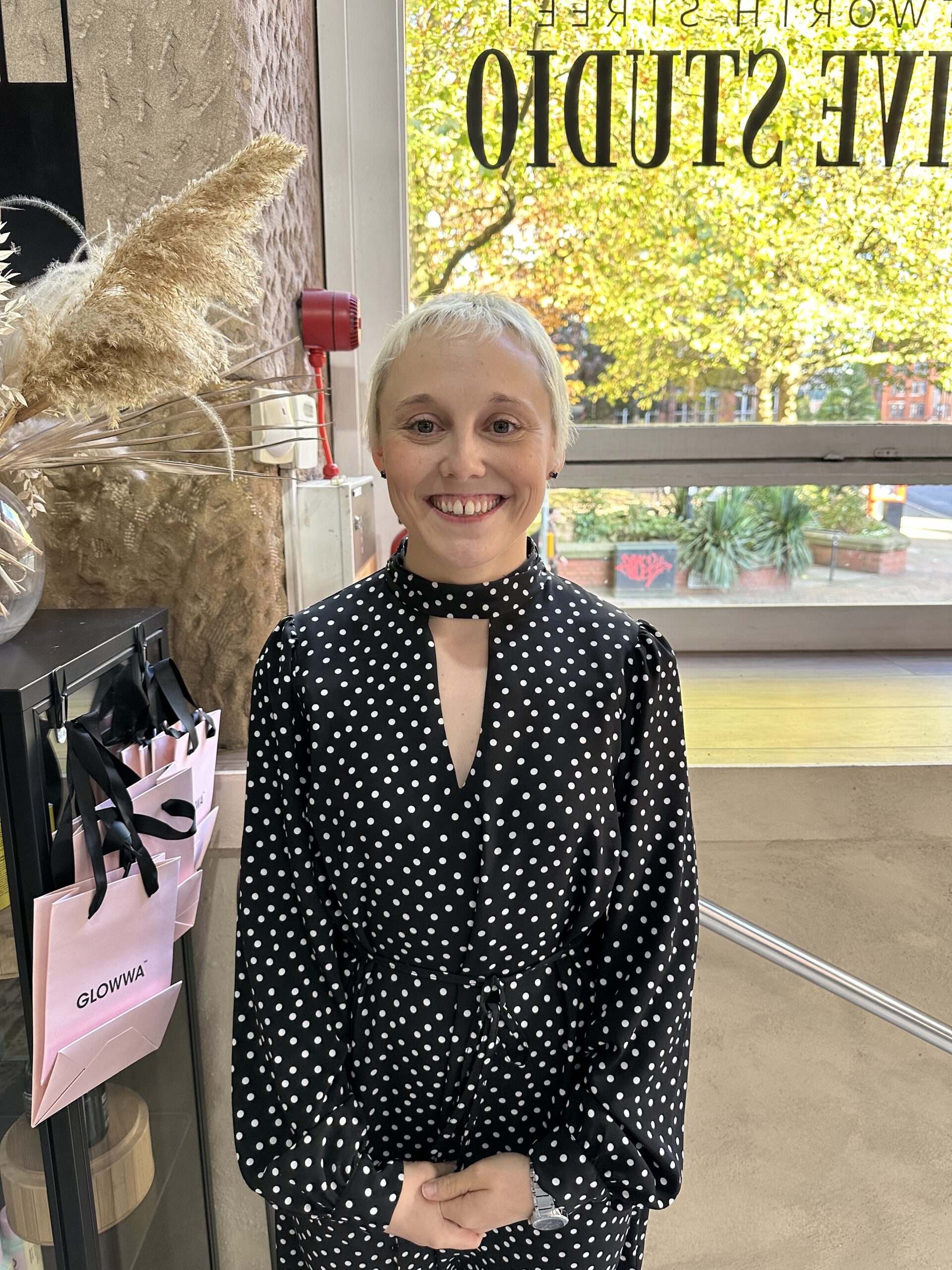 Rebecca Johnston rebecca johnston, manchester-based hairdresser wearing a polka dot dress smiling for a photo