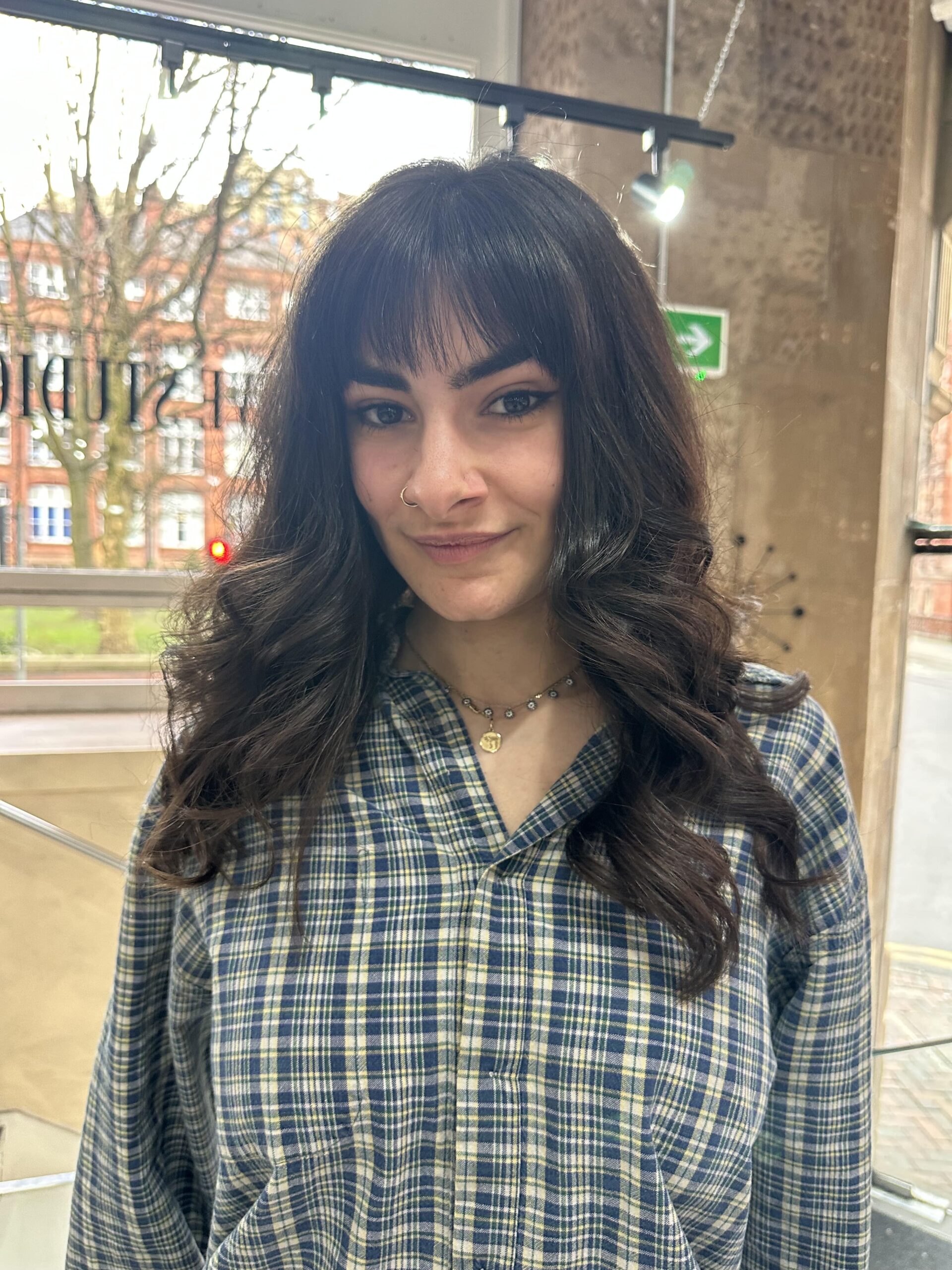 brunette woman in chequered shirt