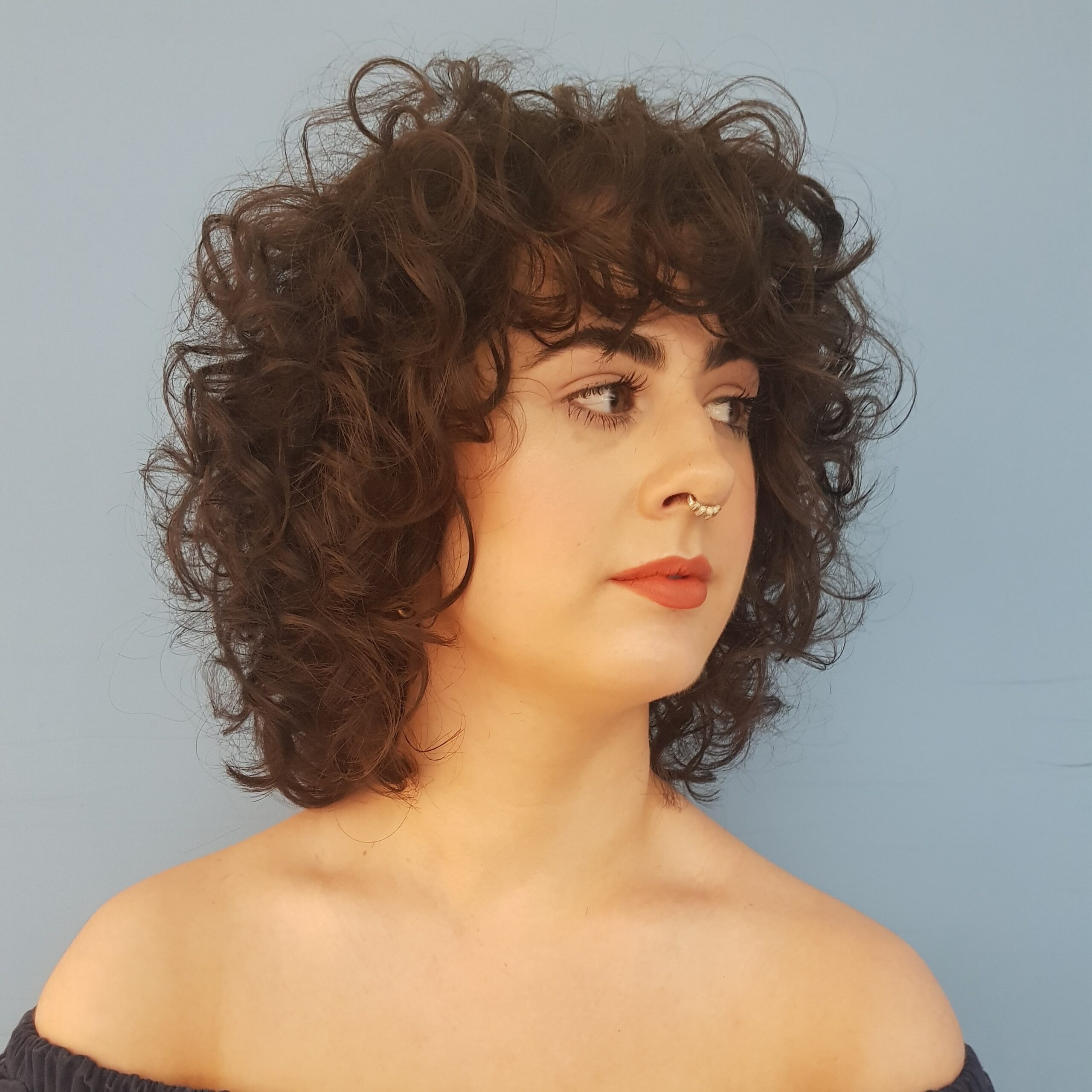 photo of a woman with short curly hair