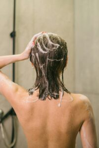 lady in the shower washing her hair