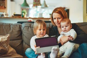 woman with 2 kids on an ipad