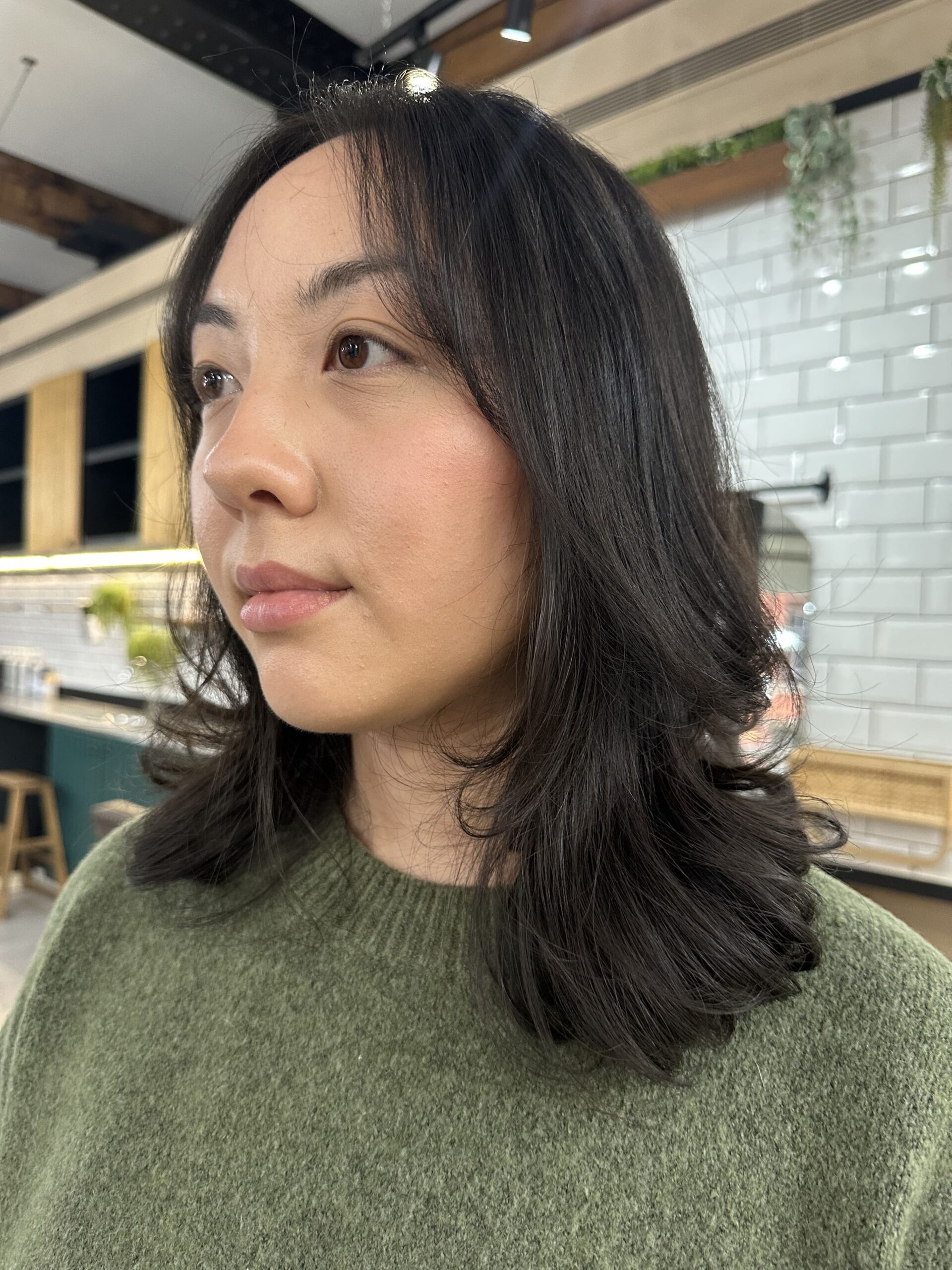woman facing forward with mid length black hair