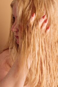 lady with hands through her blonde hair