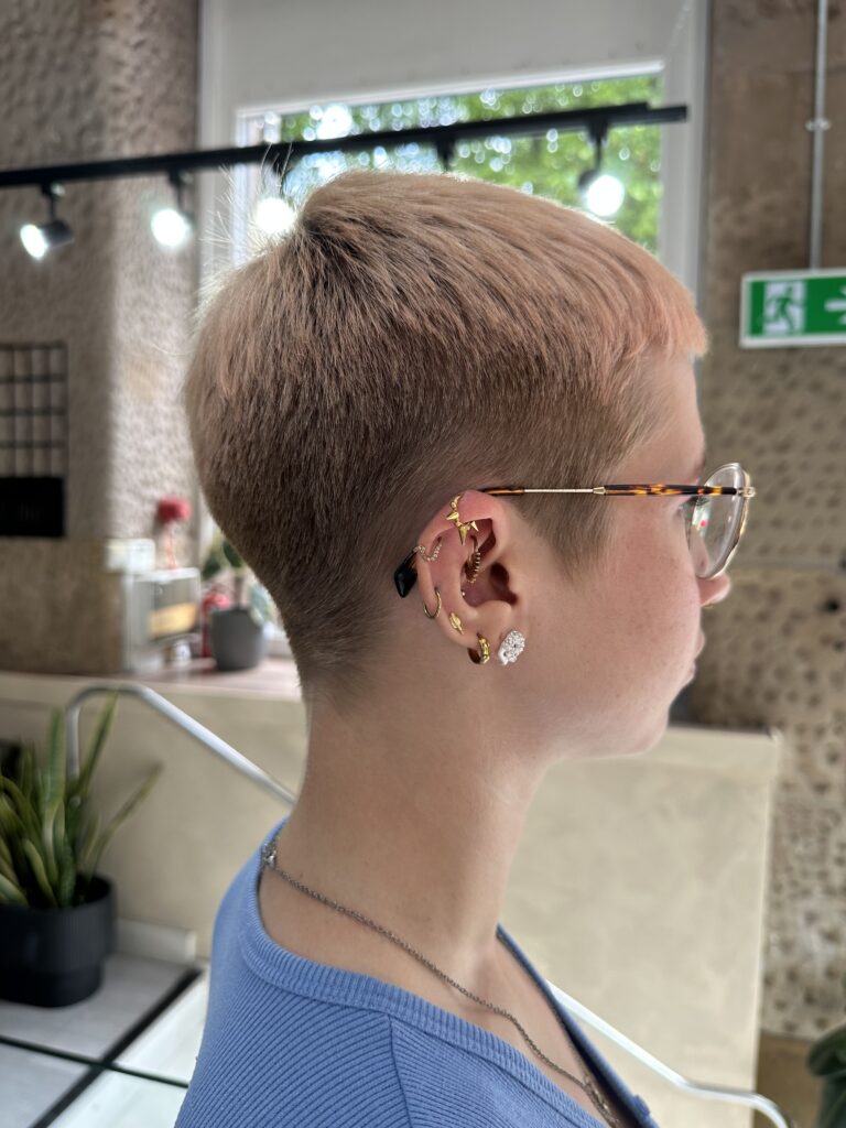 side profile of woman in glasses showing her short haircut
