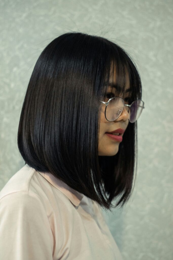 lady in glasses from the side showing her bob off